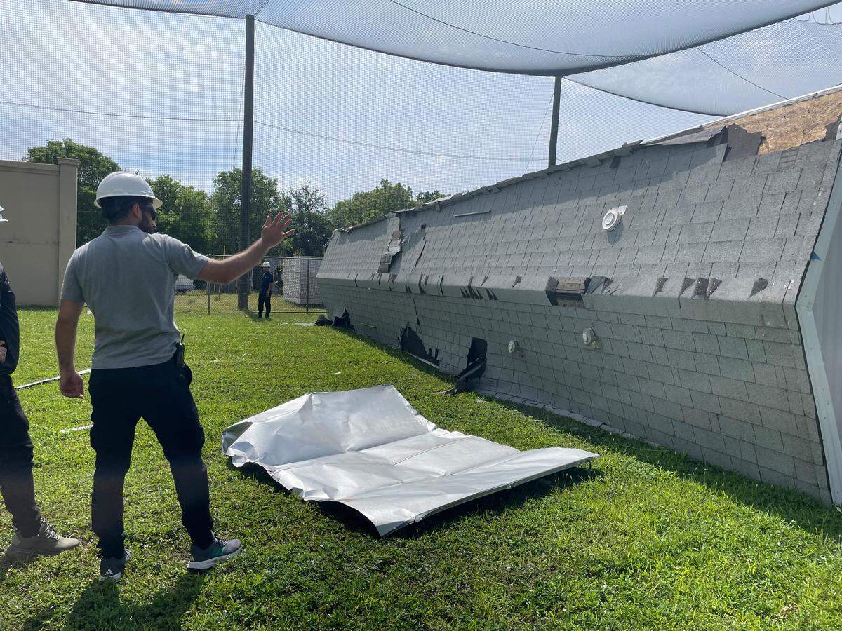 Researcher inspects the damage of a roof of a fallen manufactured home at Florida International University’s School of Engineering on May 13, 2026.